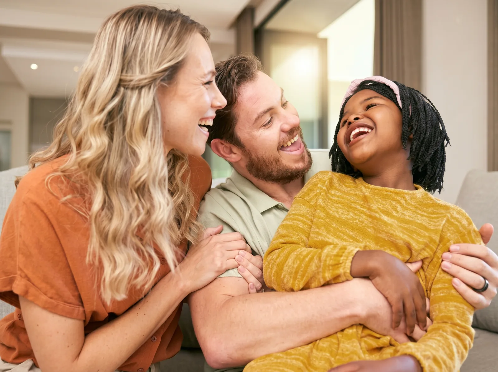 A happy family laughing together at Dr. Janood Dental in Etobicoke